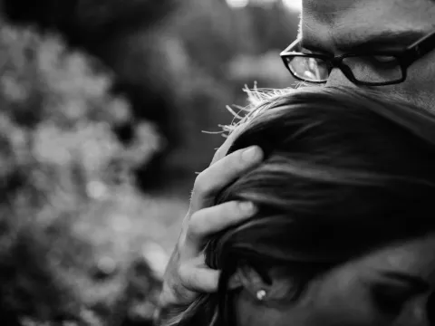 Couple photographed from a distance in open natural surroundings