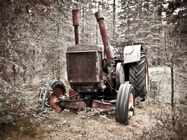 Weathered tractor sitting in grass