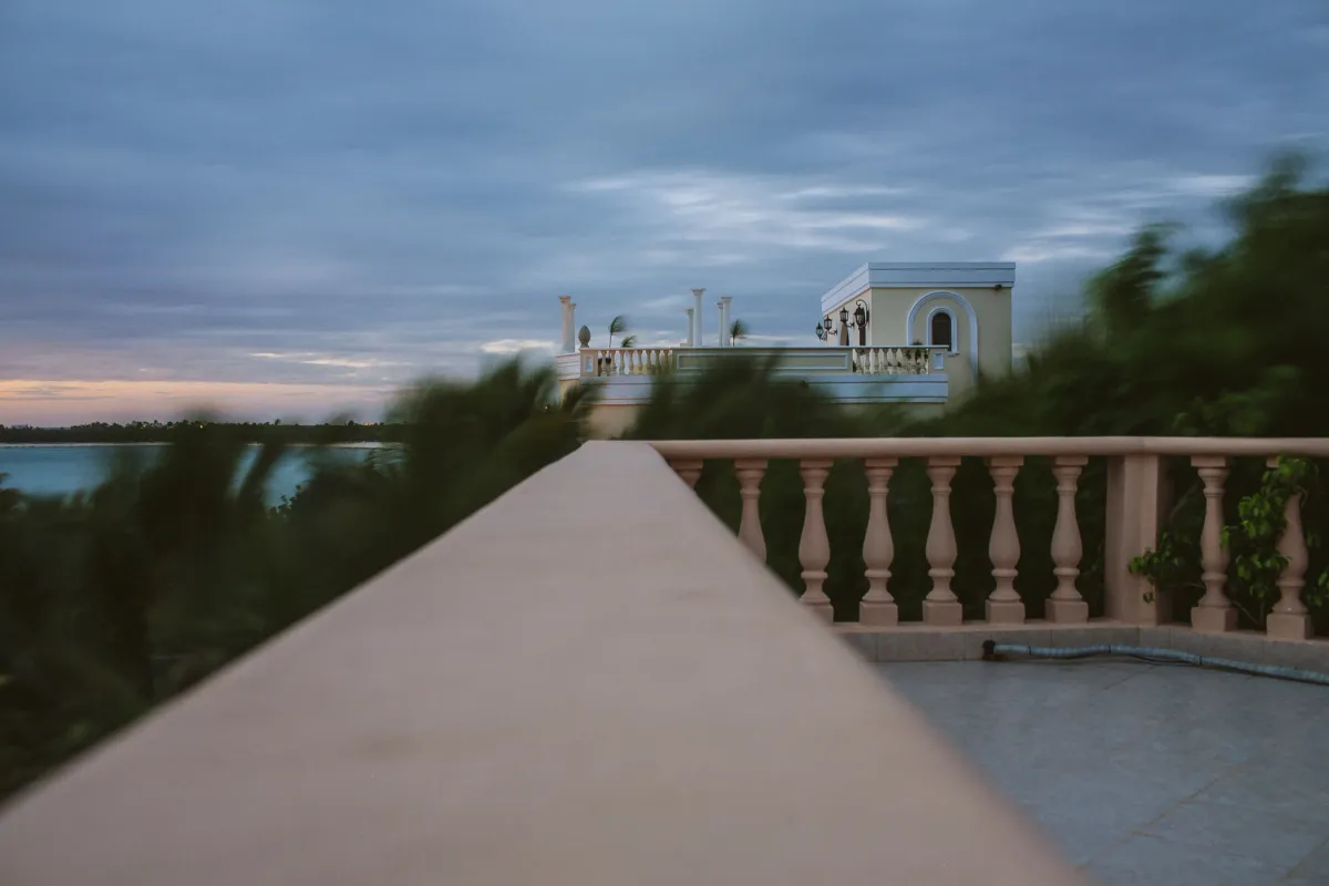 Balcony wall leading toward a soft blue ocean horizon