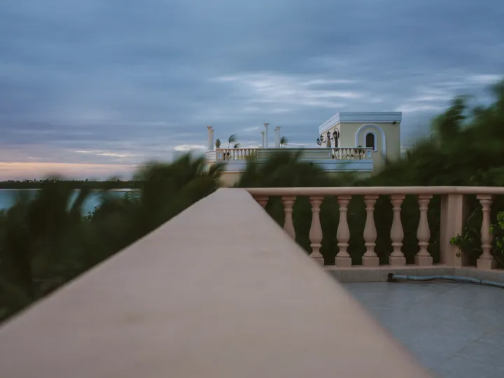 Balcony wall leading toward a soft blue ocean horizon