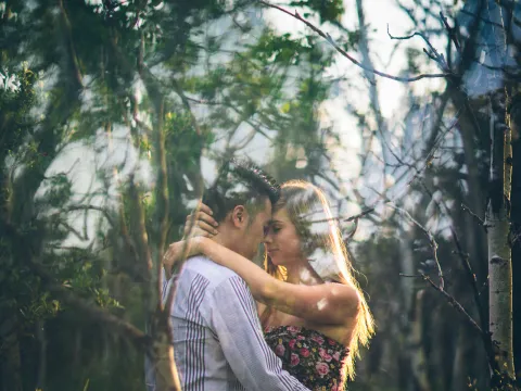 Couple embracing in birch woods during an Alberta engagement session