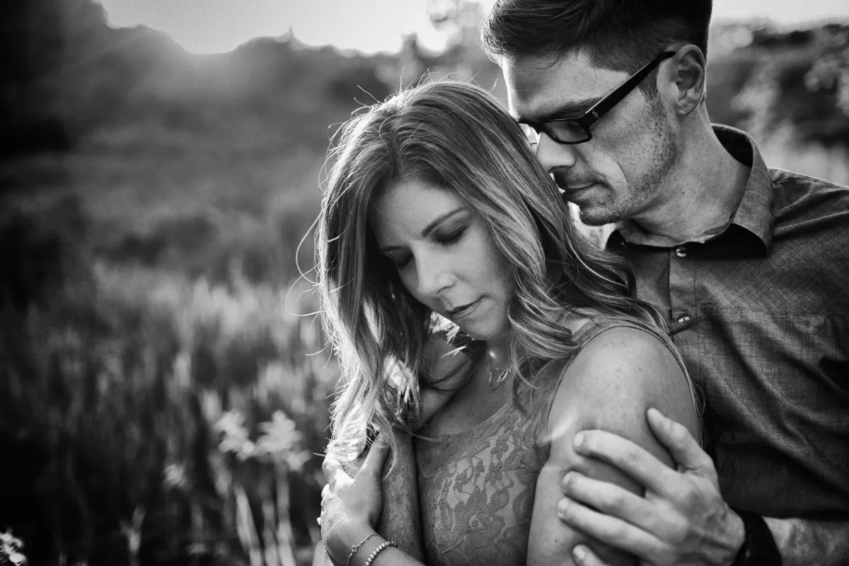 Black and white close engagement portrait with foothills in the background