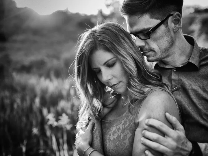 Black and white close engagement portrait with foothills in the background