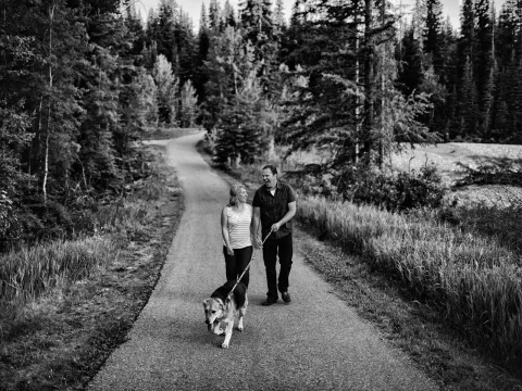 Black and white photo of a couple walking on a country road during an engagement session