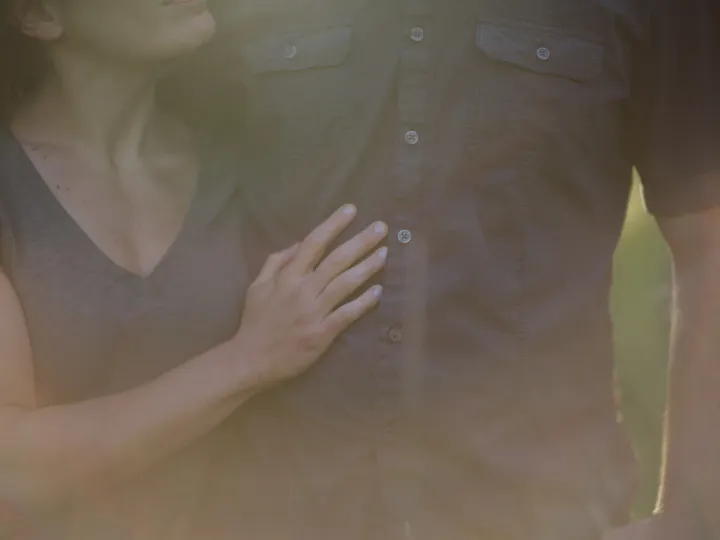 Close couple portrait with sunlight flare during an Alberta engagement session