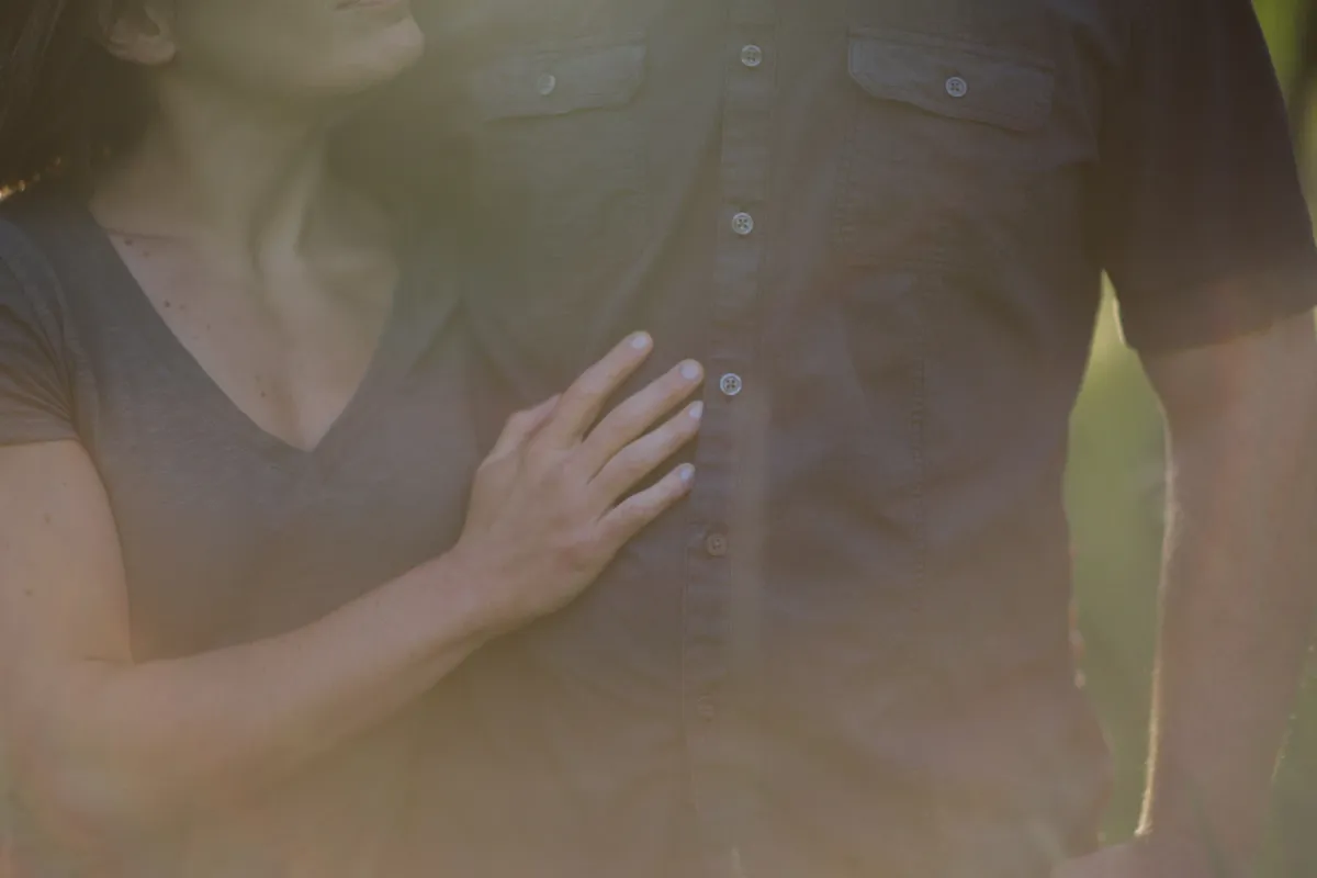 Close couple portrait with sunlight flare during an Alberta engagement session