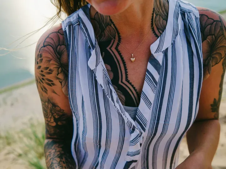 Cropped portrait of a person in a striped shirt and warm sunlight