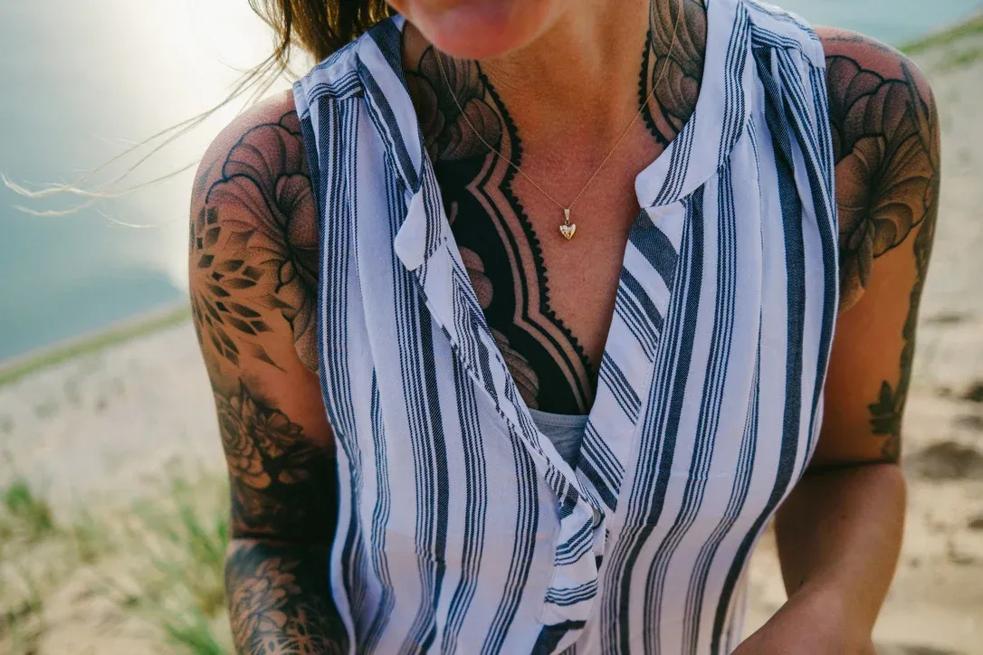 Cropped portrait of a person in a striped shirt and warm sunlight