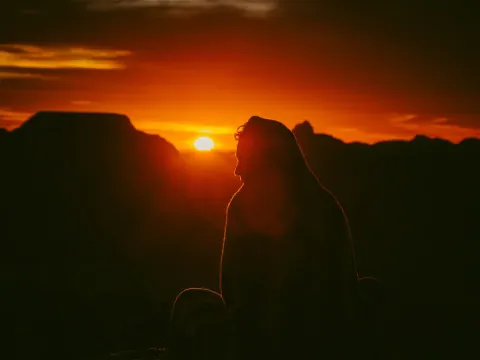 Warm sunset seen through glass with a dark foreground silhouette