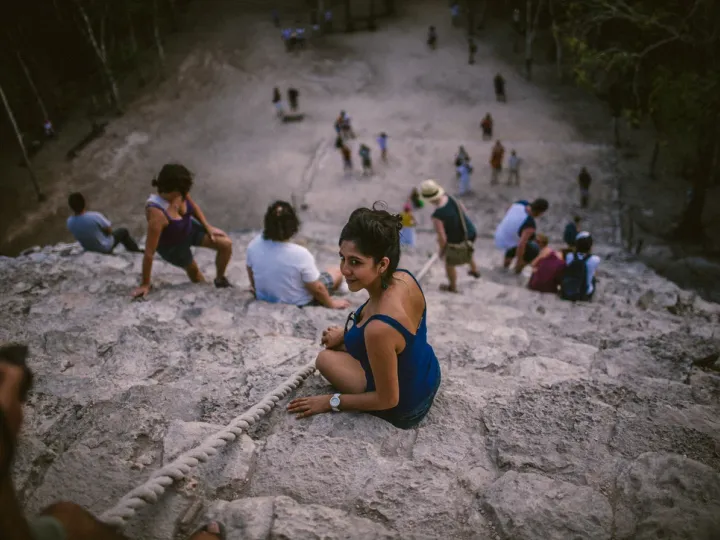 People gathered across pale stone in a dry landscape