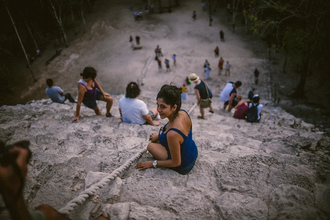 People gathered across pale stone in a dry landscape