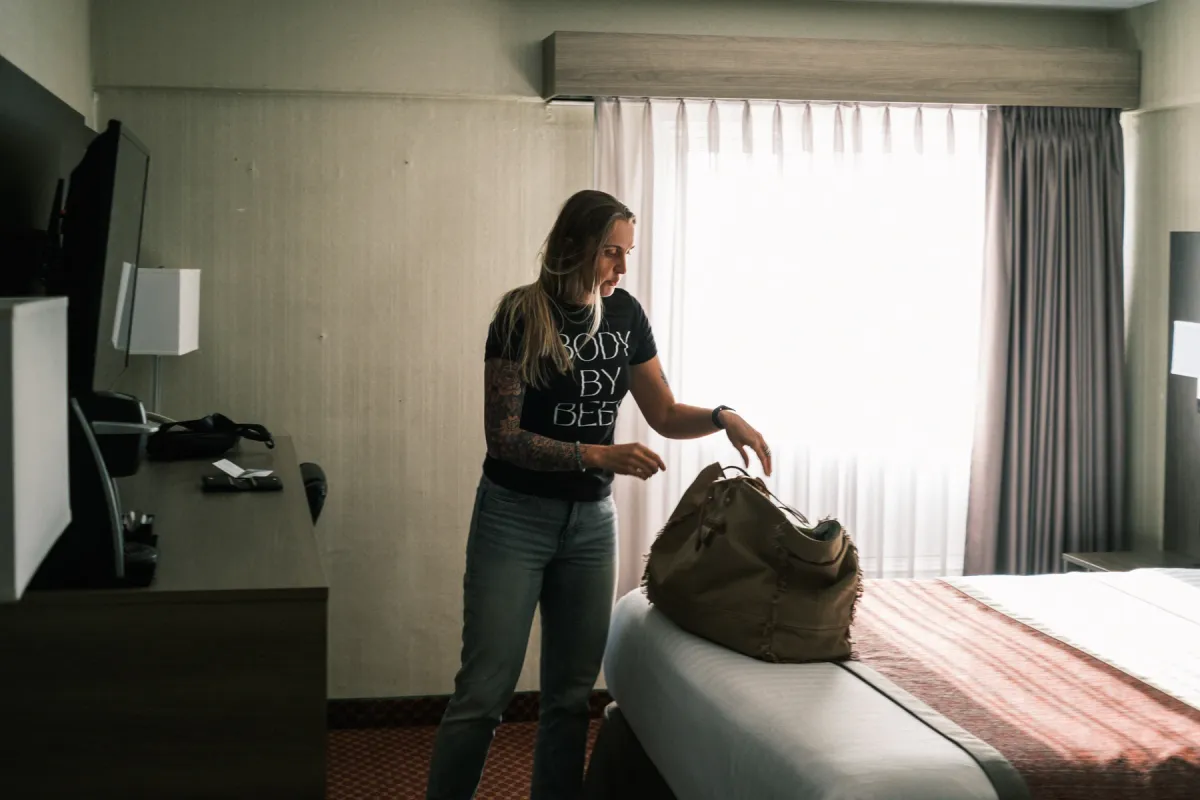 Resting Beef Face founder packing a bag in a hotel room before an Alberta market day