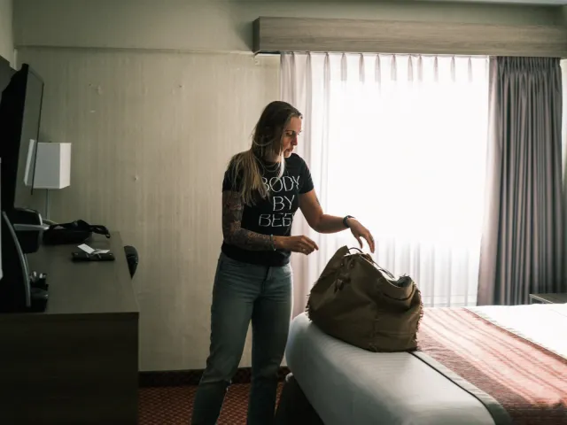 Resting Beef Face founder packing a bag in a hotel room before an Alberta market day