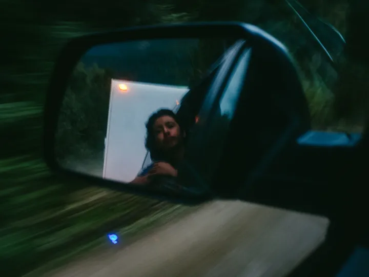 Road scene reflected in a vehicle mirror