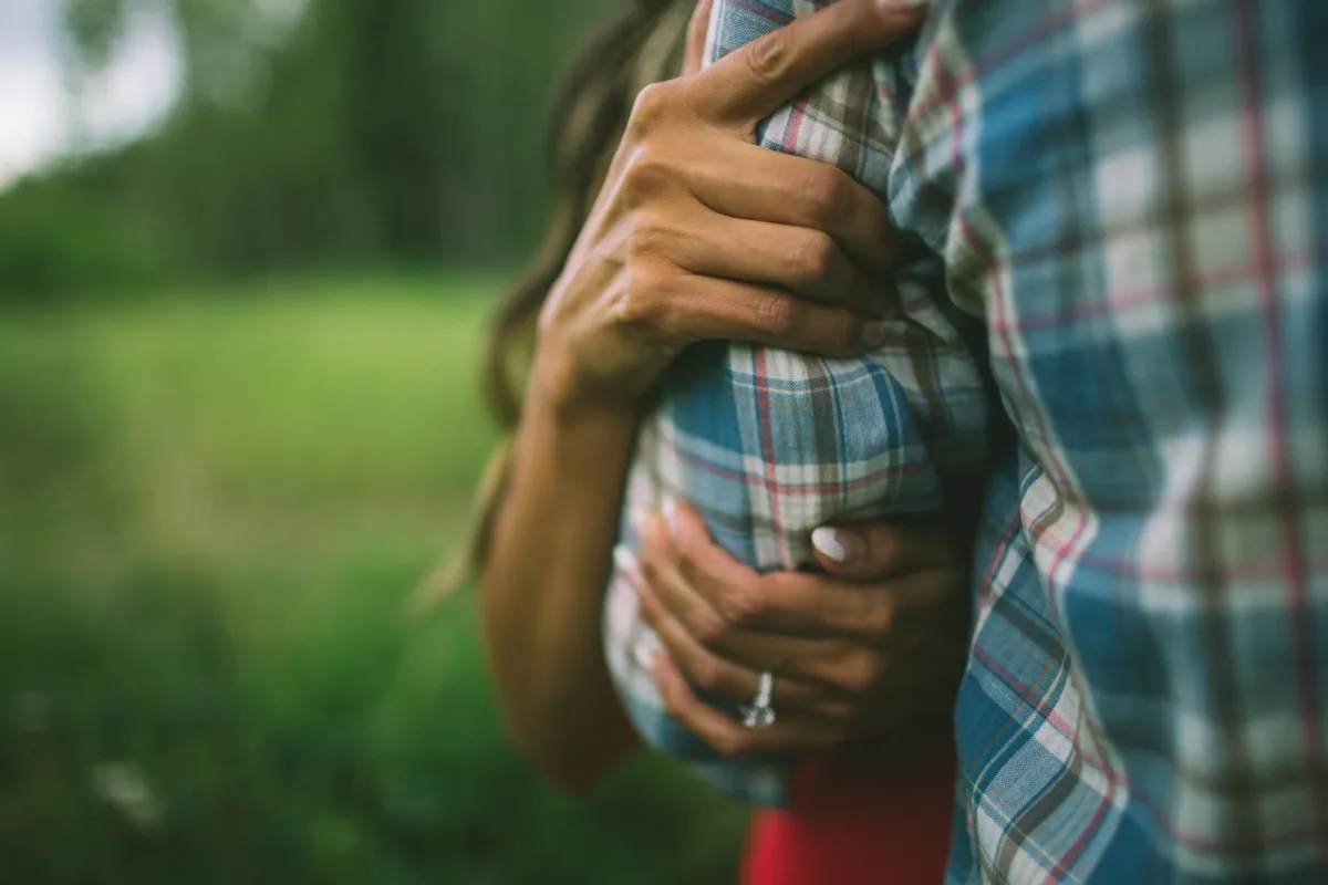 Couple standing close together in soft natural light