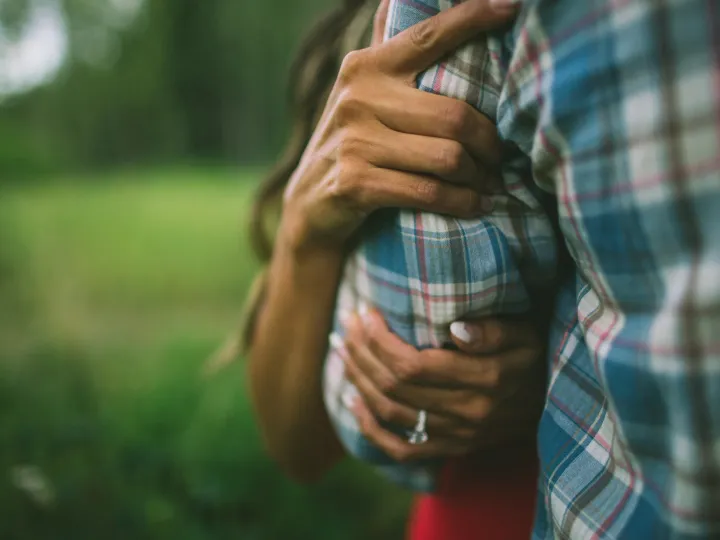 Couple standing close together in soft natural light